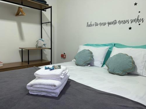 a bedroom with a bed with towels on it at BORA BORA RESIDENCE in Joinville