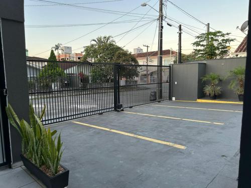 a black wrought iron gate in a parking lot at BORA BORA RESIDENCE in Joinville