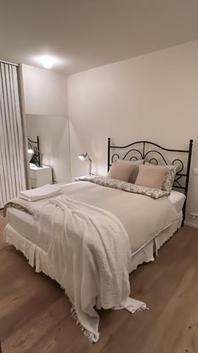 a white bedroom with a large bed with pillows at Reykjavikrental in Reykjavík