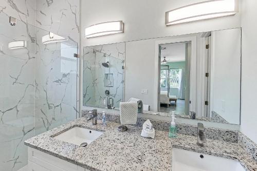 a bathroom with a sink and a large mirror at The Blue Coral in Naples