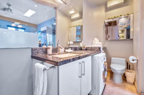 a bathroom with a sink and a toilet at Beach Baller Bungalow in San Diego