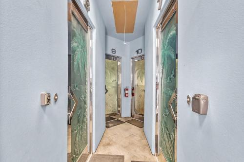 a hallway in a building with a hallway with mirrors at Beach Baller Bungalow in San Diego