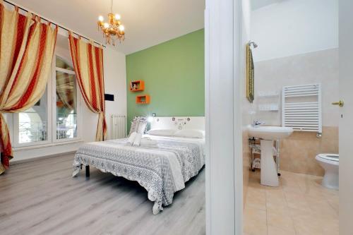 a bedroom with a bed and a sink and a toilet at Lucky Holiday Rooms in Rome