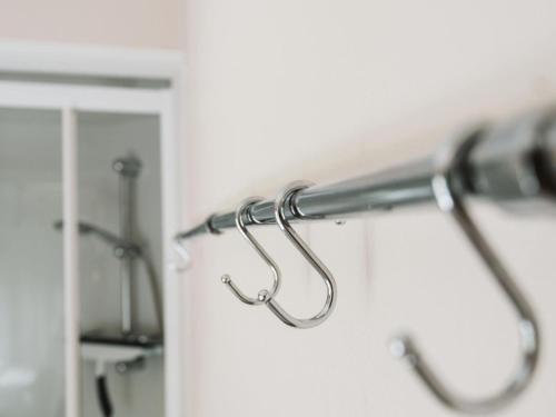 a towel rack in a bathroom with a mirror at Cozy chalet for 5p with garden in a lovely area near Goedereede in Goedereede