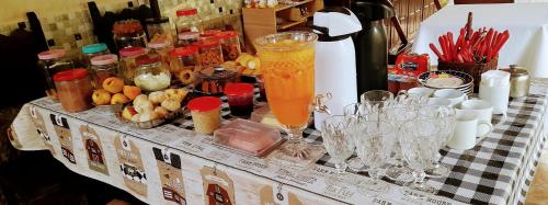 a table with glasses and drinks on a table at Hostel Néli in Aparecida