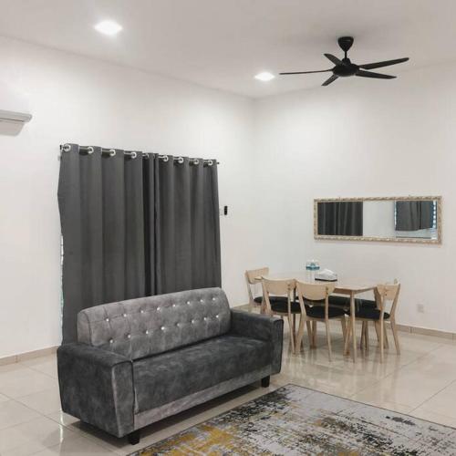 a living room with a couch and a table at Salak Pekerti Homestay KLIA KLIA2 in Sepang