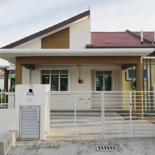 a white house with a fence in front of it at Salak Pekerti Homestay KLIA KLIA2 in Sepang