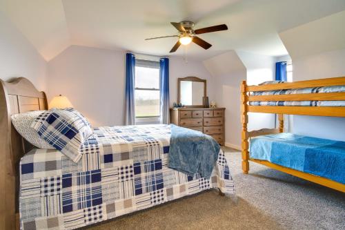 a bedroom with a bunk bed and a ceiling fan at Rural New York Vacation Rental with Deck in Romulus