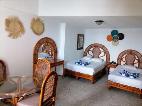 Una cama o camas en una habitación de Suites a pie de playa