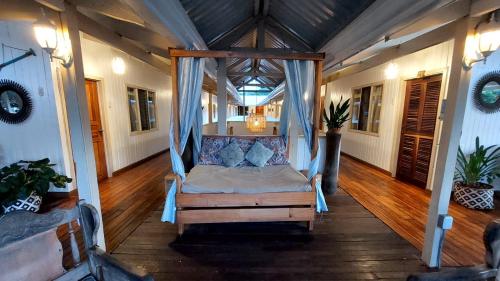 a porch with a bed in a house at Hotel M&M Beach House in Coco