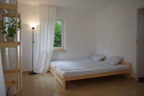 a bed in a room with a window at Gosciniec Wydminy in Wydminy