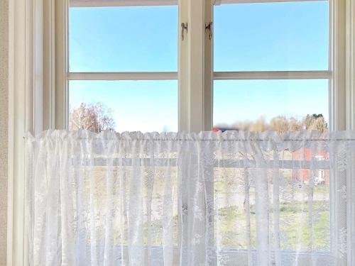 a window with a white curtain in a room at 4 person holiday home in MARIESTAD-By Traum in Mariestad