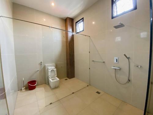 a bathroom with a shower and a toilet at C02 EuroStyle Seri Alam Homestay in Masai