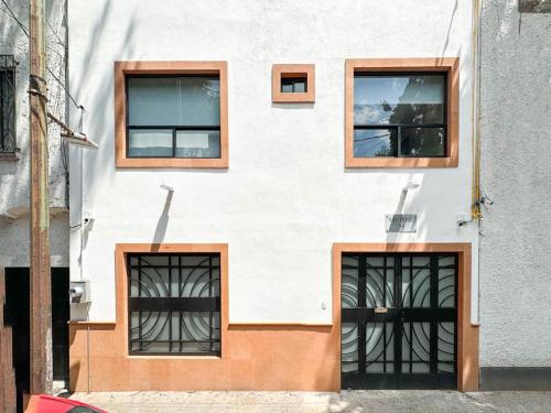 a building with four windows on the side of it at Casa Yautepec Condesa in Mexico City