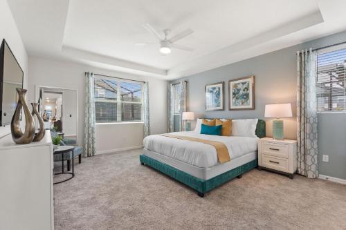 a bedroom with a bed and a tv in it at Sea Shore at Solara Resort by Shine Villas #401 villa in Orlando