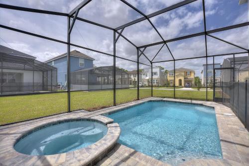 a large swimming pool in a yard with a house at Sea Shore at Solara Resort by Shine Villas #401 villa in Orlando