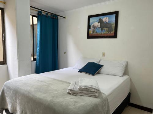 a bedroom with a bed with a towel on it at Lovely apartment in the best zone of Medellin in Medellín