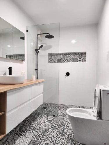 a bathroom with a tub and a sink and a toilet at Heritage cottage in South Hobart in Hobart