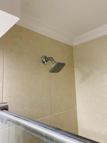 a shower with a shower head on a wall at Bogotá Kings 300 in Bogotá