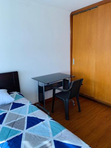 a bedroom with a desk and a bed and a table at Bogotá Kings 300 in Bogotá