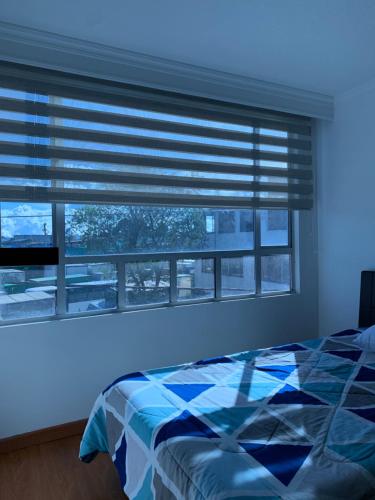 a bedroom with a window with a blue light at Bogotá Kings 300 in Bogotá
