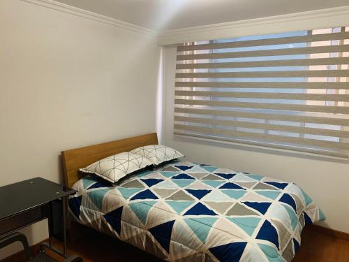 a bedroom with a bed and a window at Bogotá Kings 300 in Bogotá