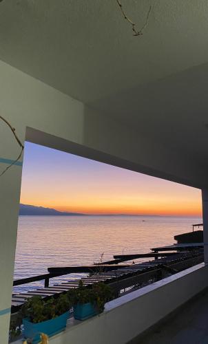 a view of the ocean from the balcony of a house at Fabeno Villa in Sarandë