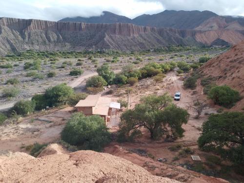 an aerial view of a mountain with a house and trees at Cabaña Misk'i Nuna, en las afueras de Tilcara in Tilcara