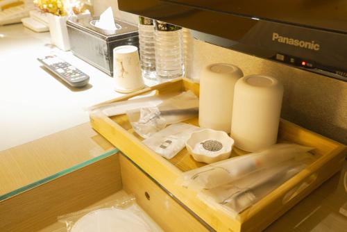 a drawer with some paper towels and a coffee machine at 銀座飯店Ginza Hotel in Taipei