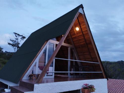 a small house with a pitched roof at ALPINA Zona C cabañas in Socorro