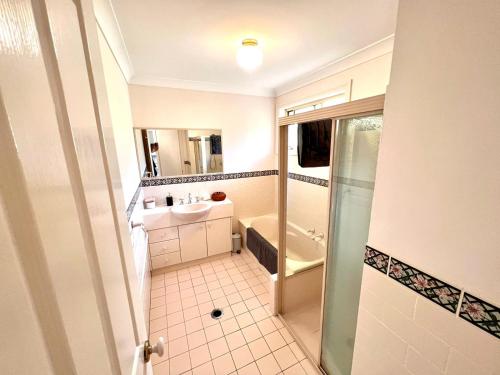a bathroom with a sink and a shower at 3 Bedroom Town house near Gosford CBD Sleeps 6 plus in Gosford
