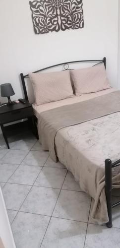 a bedroom with a bed and a desk and a bed sidx sidx sidx at menidistudios in Menídion