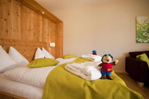a bedroom with two beds with a teddy bear sitting on them at RAMSI euer Familienhotel in Hermagor