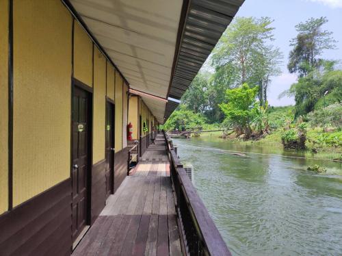 a building with a walkway next to a river at Nakakiri Resort & Spa in Hin Dat