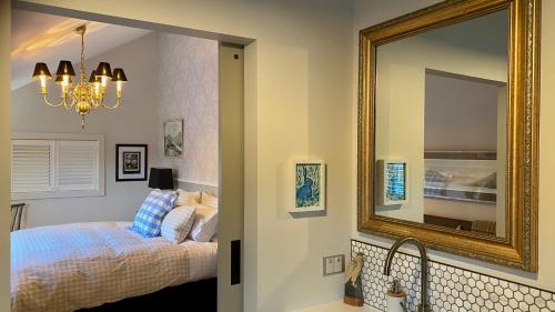 a bedroom with a bed and a mirror at The Barn at Killin B&B in Ohau