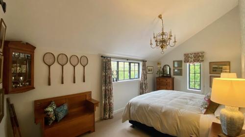 a bedroom with a bed and a chandelier at The Barn at Killin B&B in Ohau