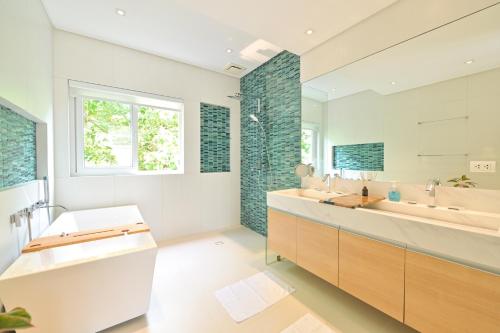 a bathroom with two sinks and a large mirror at 7Stones Boracay in Boracay