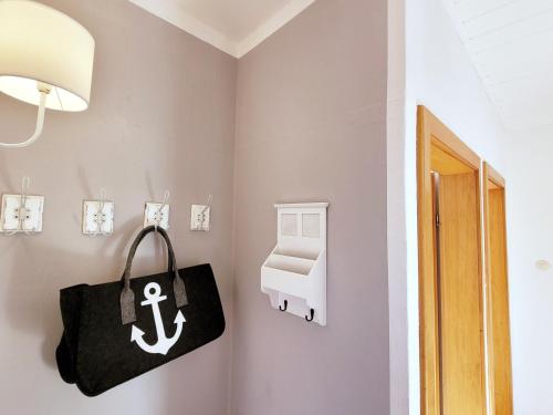a room with a black bag and an anchor on the wall at Baltrumweg 4 in Wangerland