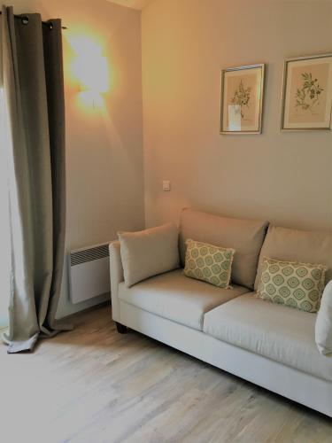 a living room with a couch and a window at Domaine Le Bois Des Dames in Chantemerle-lès-Grignan