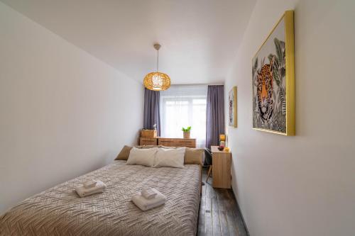 a bedroom with a bed with two towels on it at Apartments24 Laada 4 in Rakvere