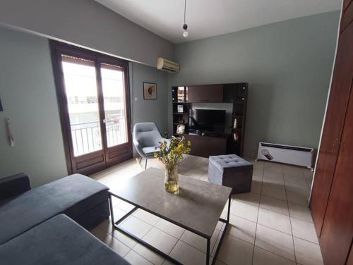 a living room with a couch and a table at Appartment near centre, bus and train stations in Pyrgos