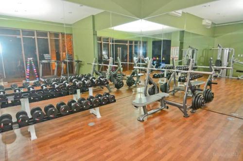 a gym with a bunch of equipment in it at Carol Crosswinds Tagaytay in Cavite
