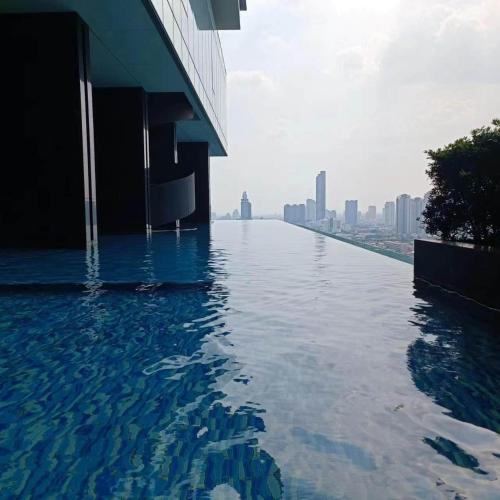a swimming pool on the top of a building at Sathon Luxury High-rise Apartment City View KingPower ,IconSiam ,BNH,Silom in Bangkok