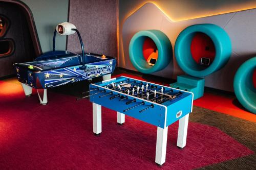 a room with a ping pong table in a room at W Dubai - The Palm in Dubai
