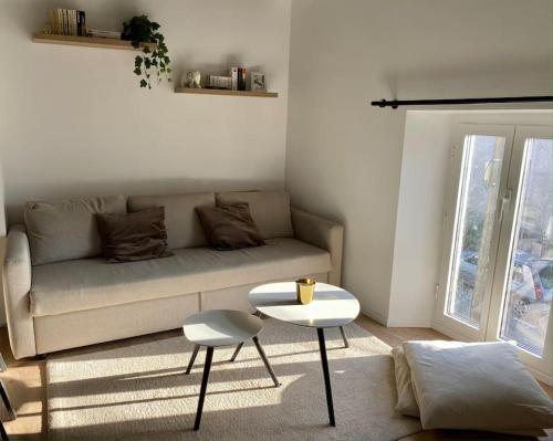 a living room with a couch and a table at Appart rénové en duplex avec terrasse et garage in Bouleurs