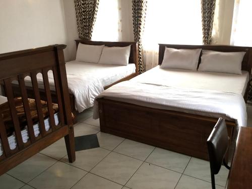 two beds sitting next to each other in a room at Hill Crest Holiday Bungalow in Diyatalawa
