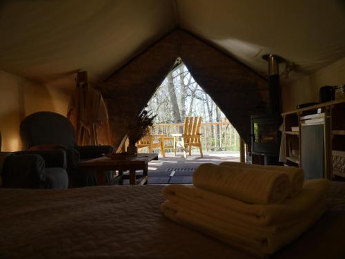 a room with a bed in a tent at Mežurgu teltis in Dikļi