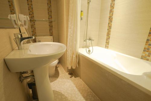 a bathroom with a sink and a toilet and a tub at 銀座飯店Ginza Hotel in Taipei