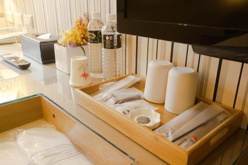 a wooden drawer filled with lots of items on a desk at 銀座飯店Ginza Hotel in Taipei