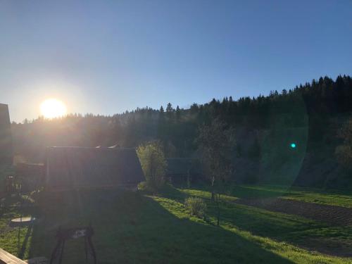 a view of a yard with the sunset in the background at Soul House in Pilipets